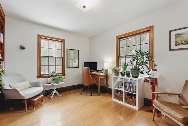 office space with light wood-style flooring and baseboards