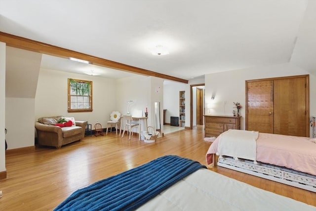 bedroom with baseboards and wood finished floors