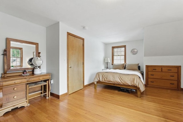 bedroom with light wood-style flooring and baseboards