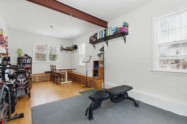 exercise room featuring light wood-style flooring