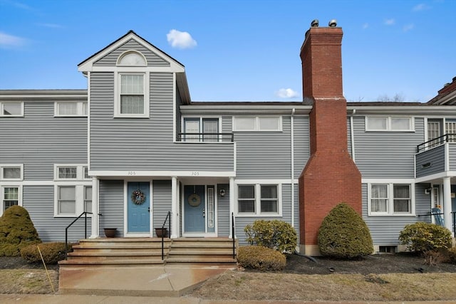 townhome / multi-family property with a chimney