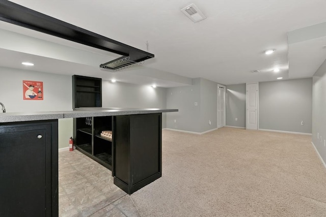 bar with bar, visible vents, light carpet, and baseboards