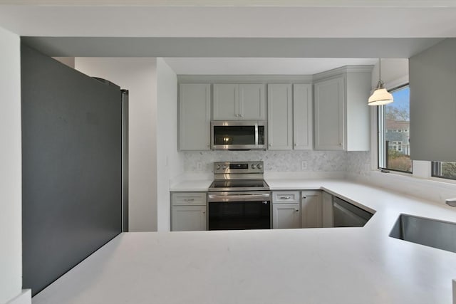 kitchen featuring a sink, stainless steel appliances, gray cabinets, and light countertops