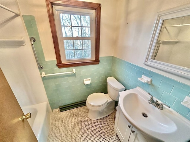 full bathroom featuring toilet, vanity, tile patterned flooring, tile walls, and shower / tub combination