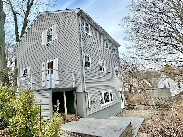 back of property featuring a deck