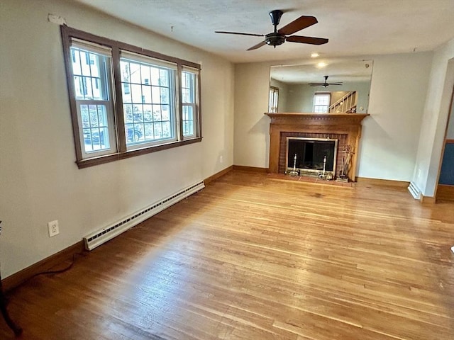 unfurnished living room with light wood-type flooring and baseboard heating