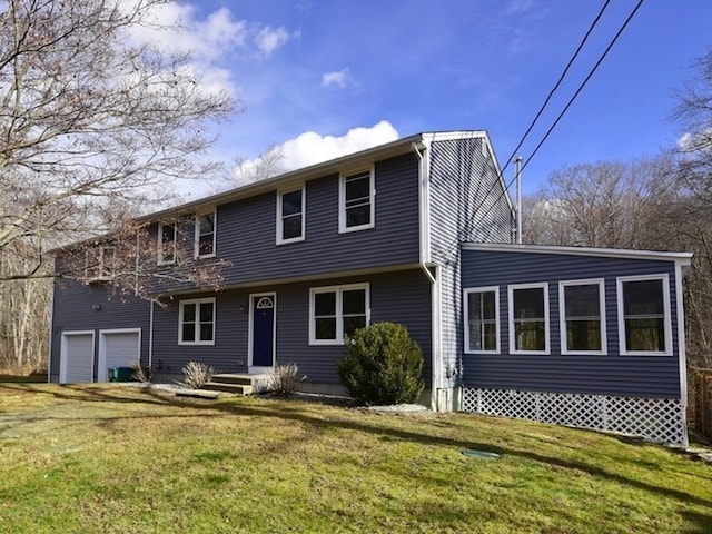 view of front of home with a garage and a front lawn