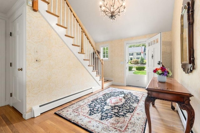 73 Greylock Rd, Wellesley, MA 02481 - foyer entrance with stairway, light wood-type flooring, a baseboard radiator, wallpapered walls, and a chandelier