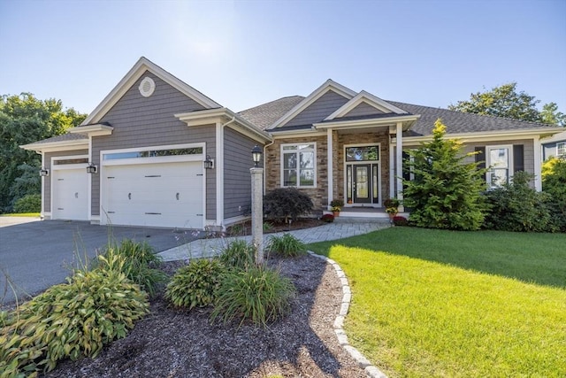 8 Garden St, Woburn, MA 01801 - view of front of house with asphalt driveway, a front lawn, and a garage