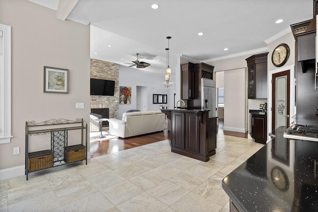 8 Garden St, Woburn, MA 01801 - kitchen featuring open floor plan, ceiling fan, dark brown cabinetry, recessed lighting, and a stone fireplace