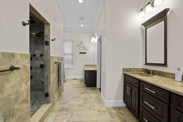 8 Garden St, Woburn, MA 01801 - full bathroom featuring crown molding, vanity, a shower stall, baseboards, and stone finish floors