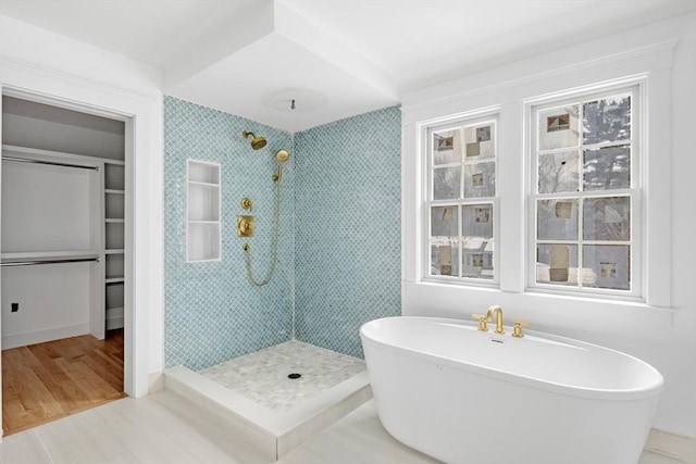 bathroom featuring independent shower and bath and hardwood / wood-style floors