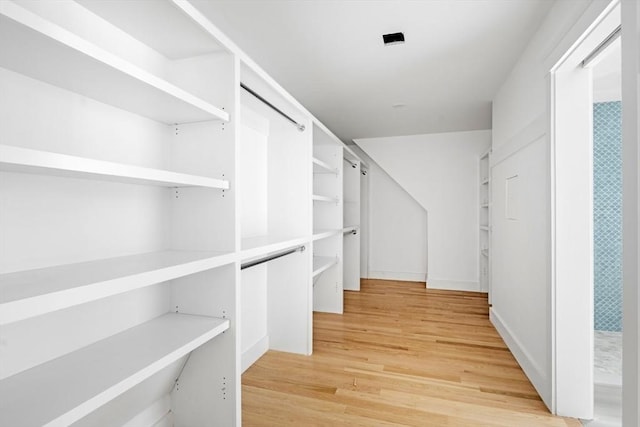 walk in closet featuring hardwood / wood-style flooring