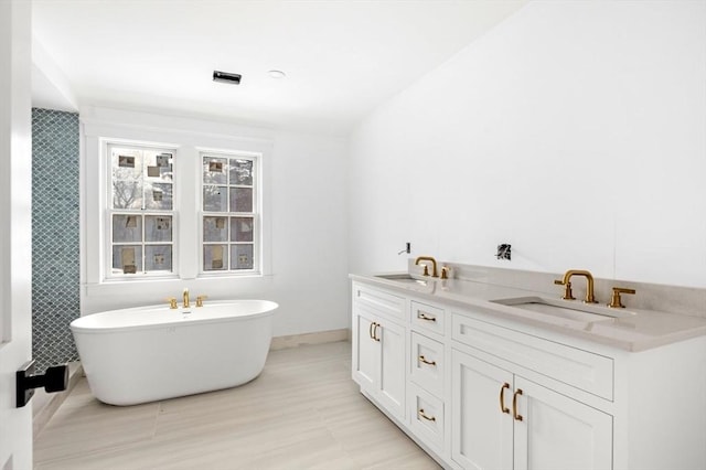 bathroom featuring vanity and a bathing tub