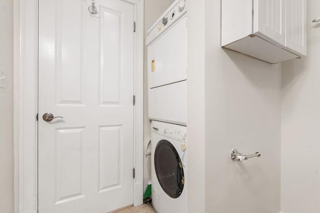 clothes washing area with stacked washer and dryer