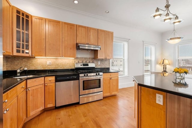 kitchen with sink, light wood-type flooring, decorative light fixtures, appliances with stainless steel finishes, and ornamental molding