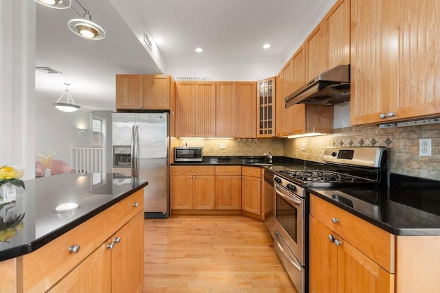 kitchen with appliances with stainless steel finishes, ornamental molding, sink, exhaust hood, and pendant lighting