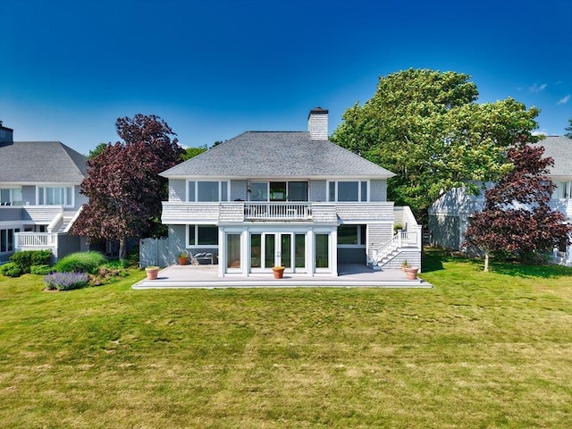 26 N Shore Dr Unit 7, Dartmouth, MA 02748 - rear view of house with a patio area, a balcony, a chimney, stairs, and a lawn