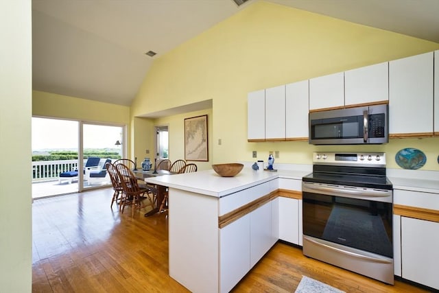 26 N Shore Dr Unit 7, Dartmouth, MA 02748 - kitchen featuring appliances with stainless steel finishes, a peninsula, high vaulted ceiling, white cabinetry, and light wood-type flooring
