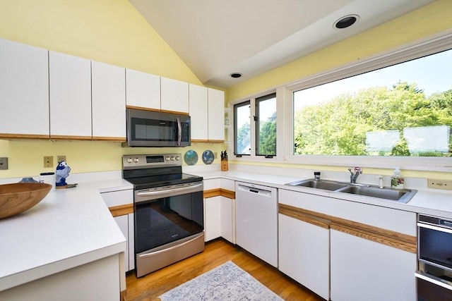 26 N Shore Dr Unit 7, Dartmouth, MA 02748 - kitchen featuring stainless steel appliances, lofted ceiling, light countertops, white cabinets, and light wood-style floors