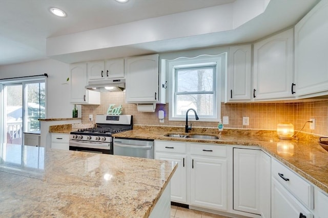 kitchen featuring white cabinetry, appliances with stainless steel finishes, light stone countertops, and sink