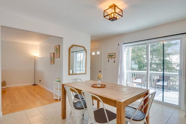 dining space featuring light tile patterned floors