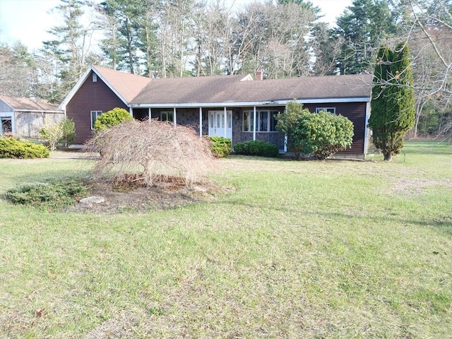 ranch-style house with a chimney and a front yard