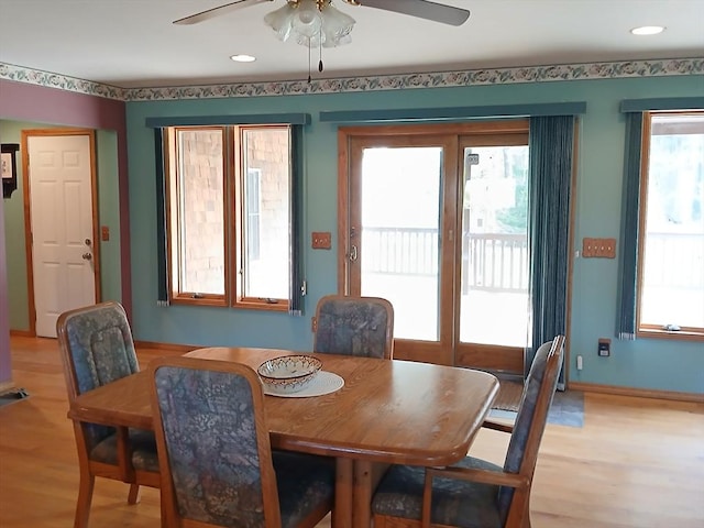 dining area featuring a ceiling fan, a healthy amount of sunlight, and light wood-type flooring