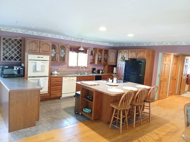 kitchen with black appliances, open shelves, a kitchen island, and light countertops