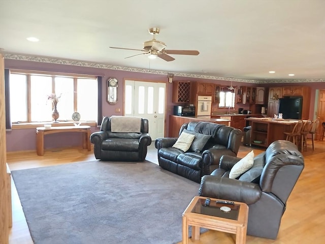 living room featuring a ceiling fan and recessed lighting