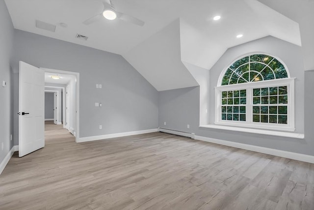 additional living space featuring baseboard heating, ceiling fan, lofted ceiling, and light wood-type flooring