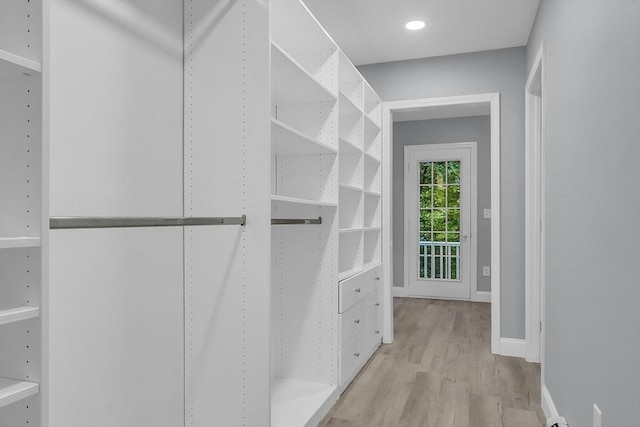 spacious closet with light hardwood / wood-style flooring