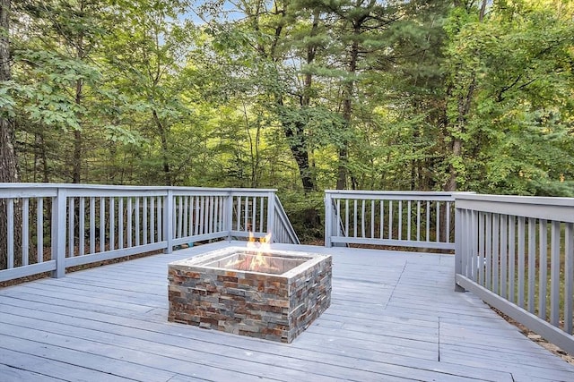 wooden deck with an outdoor fire pit