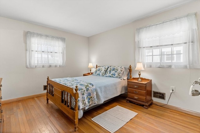 bedroom featuring baseboards and wood finished floors