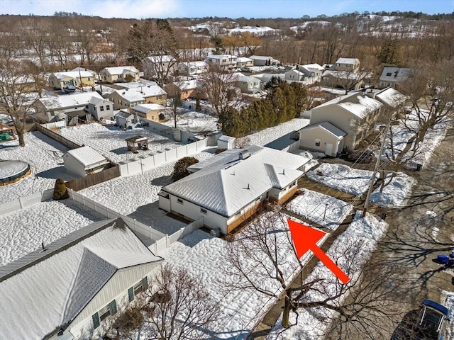 snowy aerial view featuring a residential view