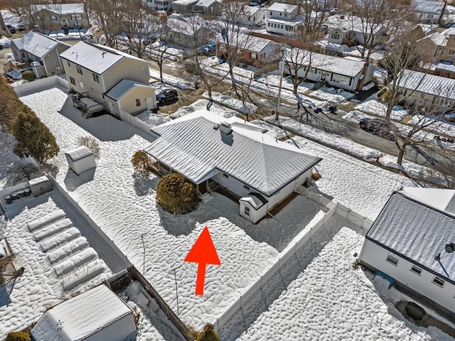 snowy aerial view with a residential view