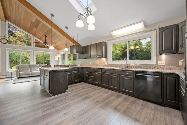 kitchen featuring dishwasher, hanging light fixtures, beamed ceiling, and sink