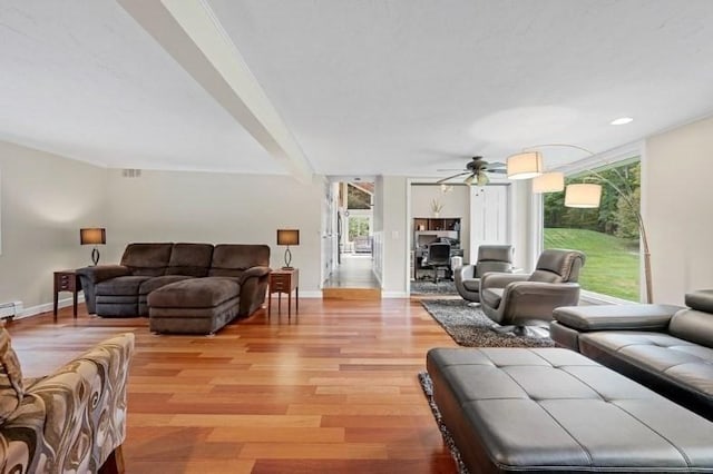 living room with beamed ceiling, light hardwood / wood-style floors, a baseboard radiator, and ceiling fan