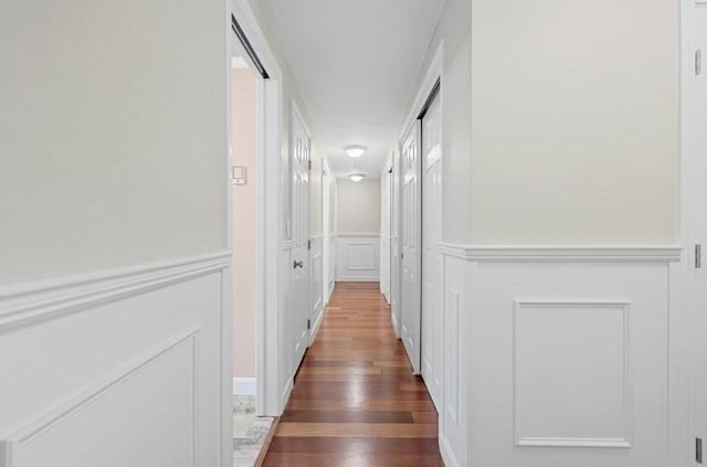 hall with dark wood-type flooring