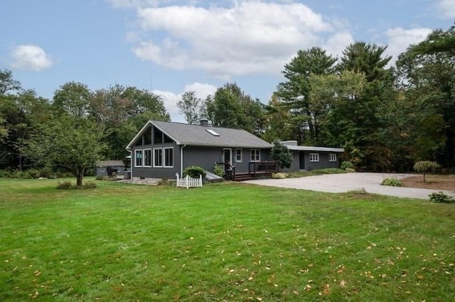 rear view of house featuring a lawn