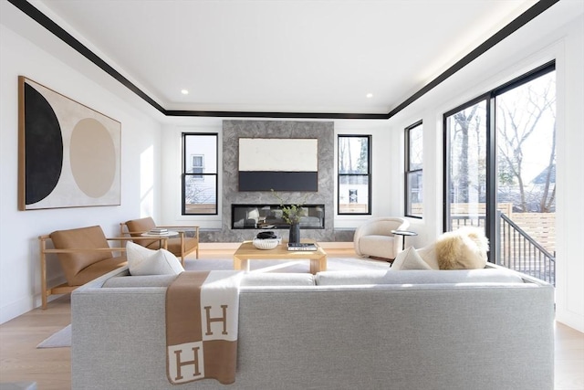 living area with recessed lighting, a fireplace, baseboards, and wood finished floors