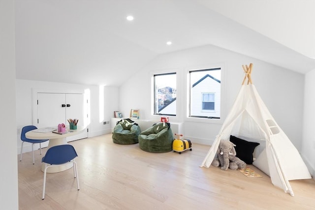 recreation room featuring recessed lighting, vaulted ceiling, baseboards, and wood finished floors