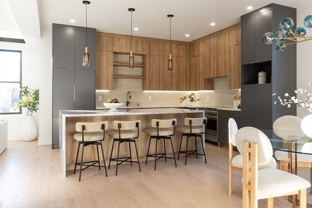 kitchen featuring light countertops, a kitchen island, decorative backsplash, and modern cabinets