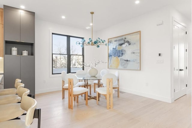 dining area featuring baseboards, light wood-style flooring, and recessed lighting