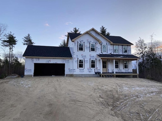 property in mid-construction with an attached garage and covered porch