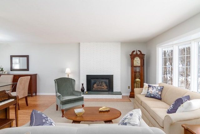 living room with light hardwood / wood-style flooring and a fireplace