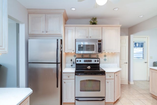 kitchen with ceiling fan, appliances with stainless steel finishes, light tile patterned flooring, and backsplash