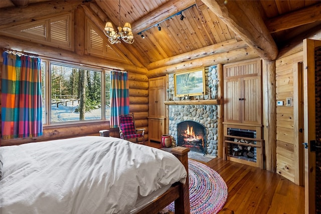 bedroom featuring hardwood / wood-style floors, a fireplace, a chandelier, lofted ceiling with beams, and wood ceiling