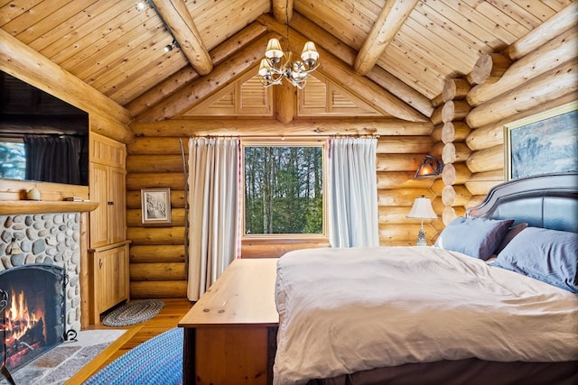 bedroom featuring rustic walls, a notable chandelier, beam ceiling, a stone fireplace, and hardwood / wood-style flooring