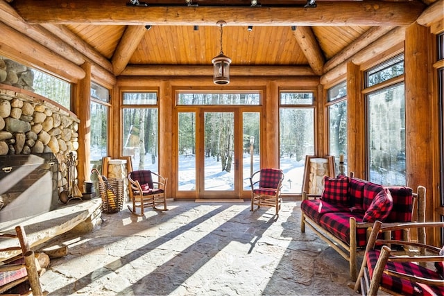 sunroom with lofted ceiling with beams, wood ceiling, and a healthy amount of sunlight